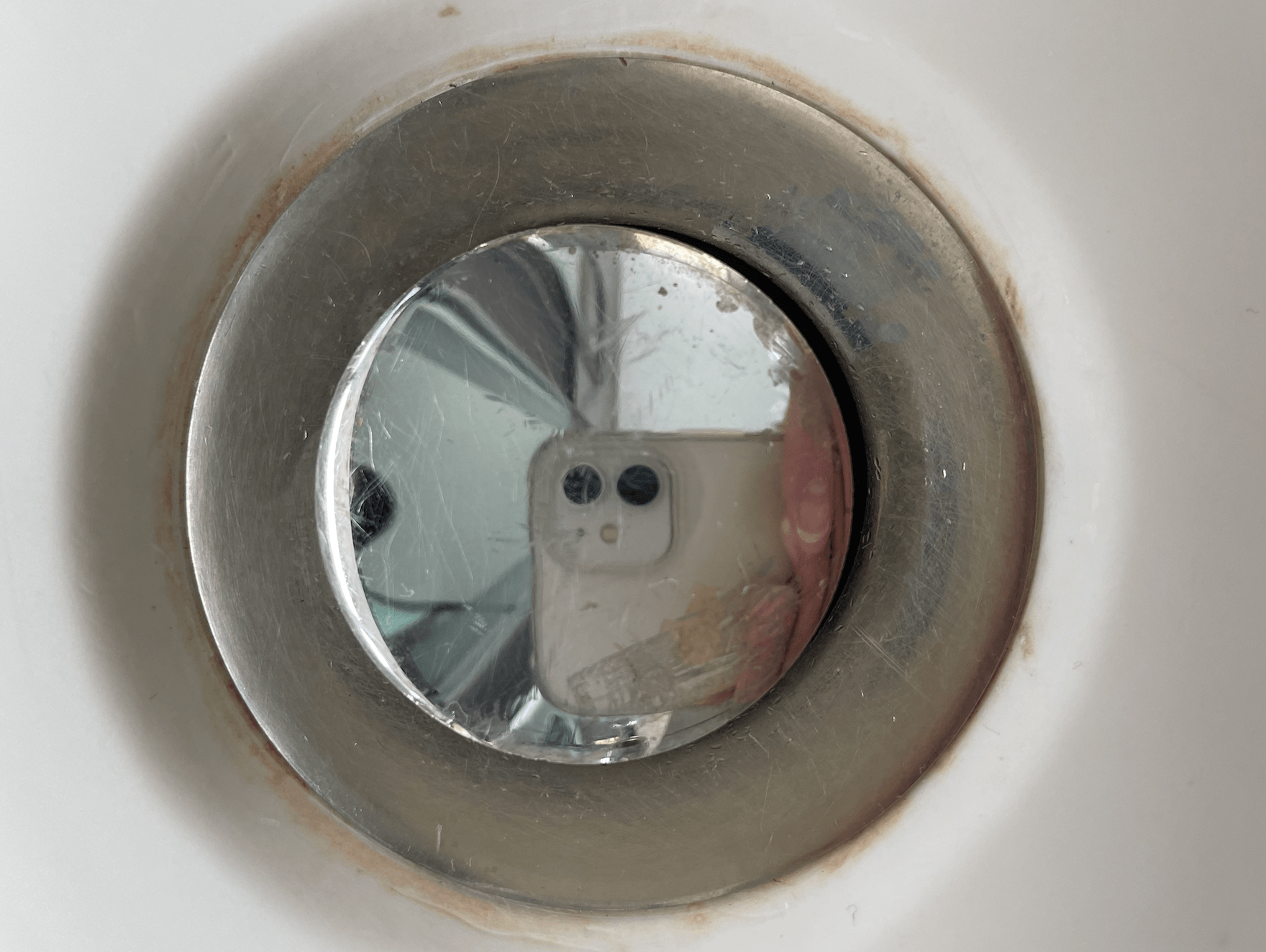Discoloured ring around a hotel sink waste fitting